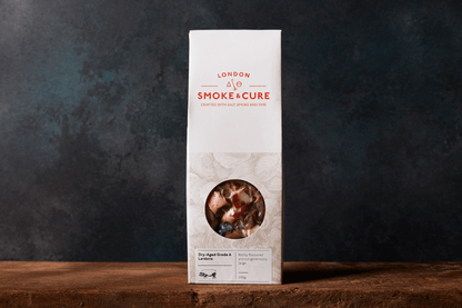 A pack of chunky London Smoke & Cure dry-aged grade A lardons in their cardboard packet.